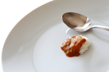 大きなお皿に一口のカレーとスプーン